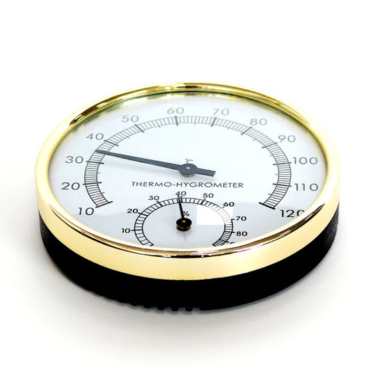 Sauna thermo-hygrometer with gold bezel and embedded black base, clear dial