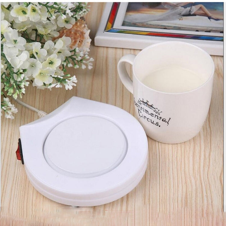 Round white electric beverage warmer base with smooth circular heating pad top