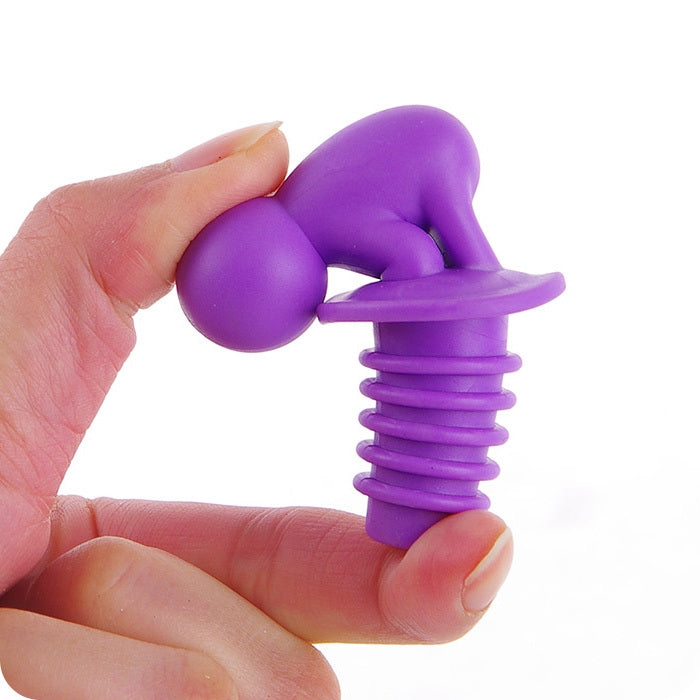 Purple silicone spiral wine stopper shaped like a cartoon figure, held by fingers