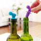 Blue and purple cartoon silicone spiral wine stoppers on green glass bottles