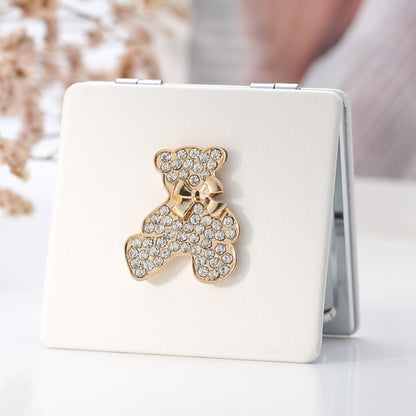White PU leather folding mini makeup mirror with rhinestone bear embellishment on front