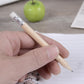 Hand holding a sharpened wooden HB pencil with silver ferrule and white eraser end