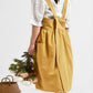 Ginger cotton-linen apron with adjustable straps, gathered waist, and front pocket