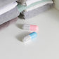 Two capsule shoe deodorizers, pink and blue with perforated vent ends