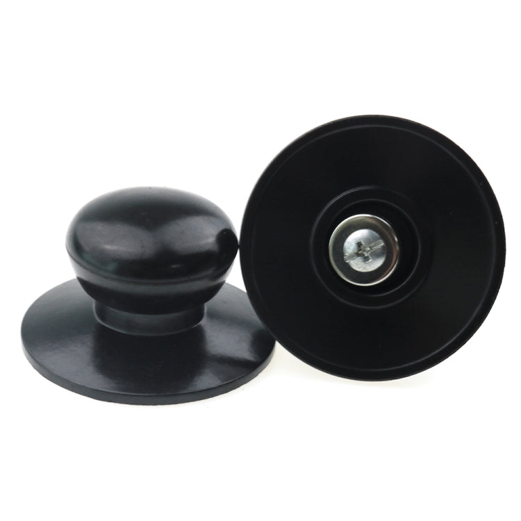 Black pot lid handle caps, one showing the center metal screw