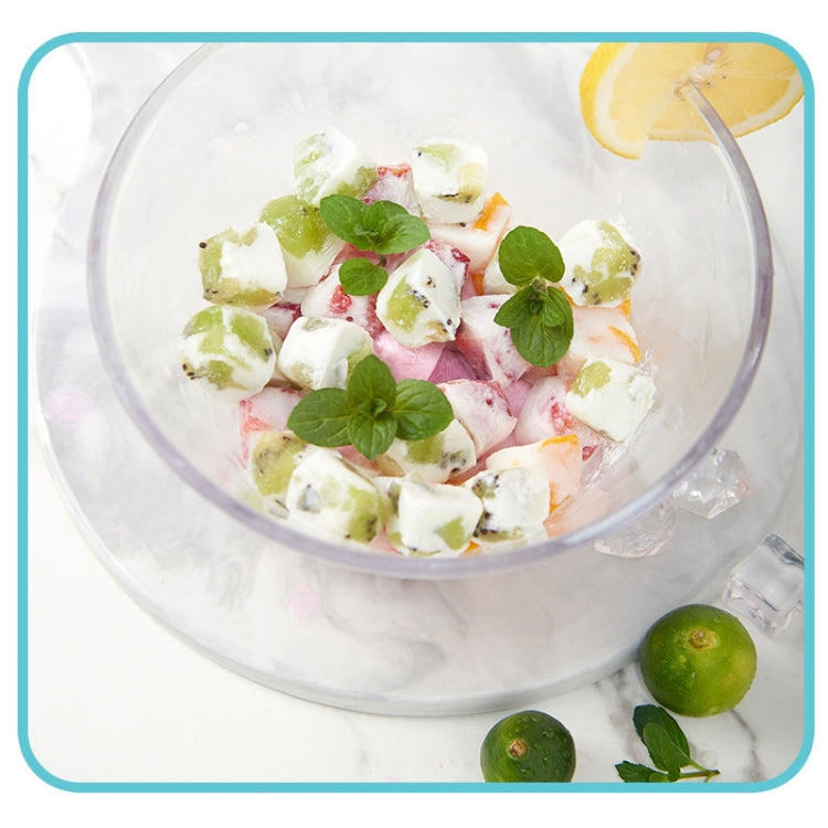 Frozen fruit ice cubes with mint leaves in a glass bowl