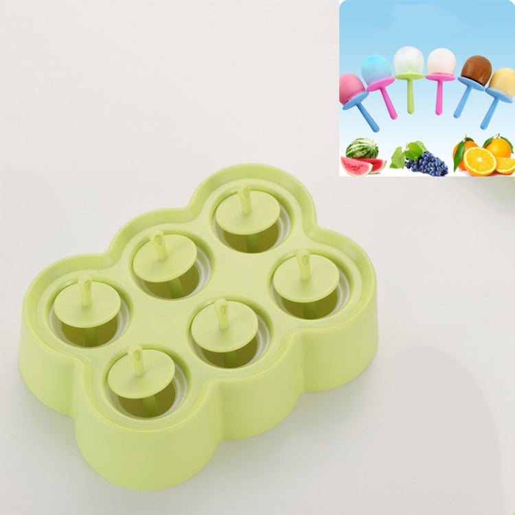 Green bear-shaped silicone popsicle mold with six round wells and stick channels.