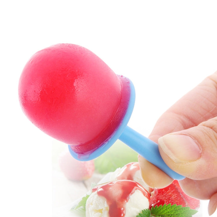 Pink ice pop on a blue stick, held in a hand.