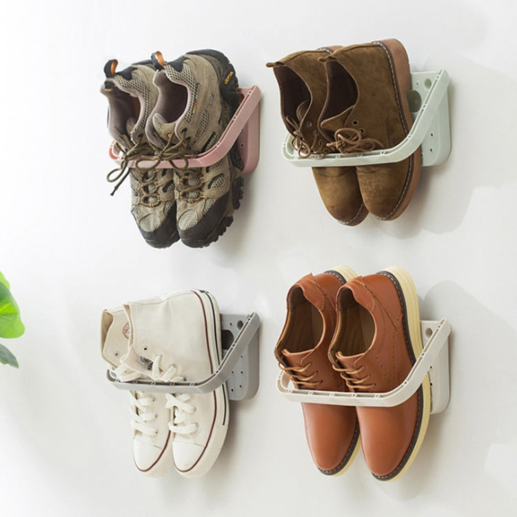 Wall hanging slipper storage rack holding multiple pairs of shoes on wall-mounted trays