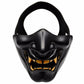 Black half-face tactical grimace mask with open mouth grin and gold-toned teeth