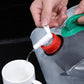 Transparent PVC drinking bag spout with red tap and green handle; pouring water.