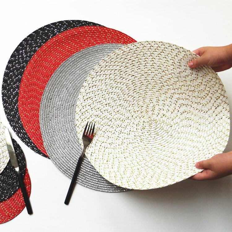 Round woven placemat stack in beige, gray, and black with red accents