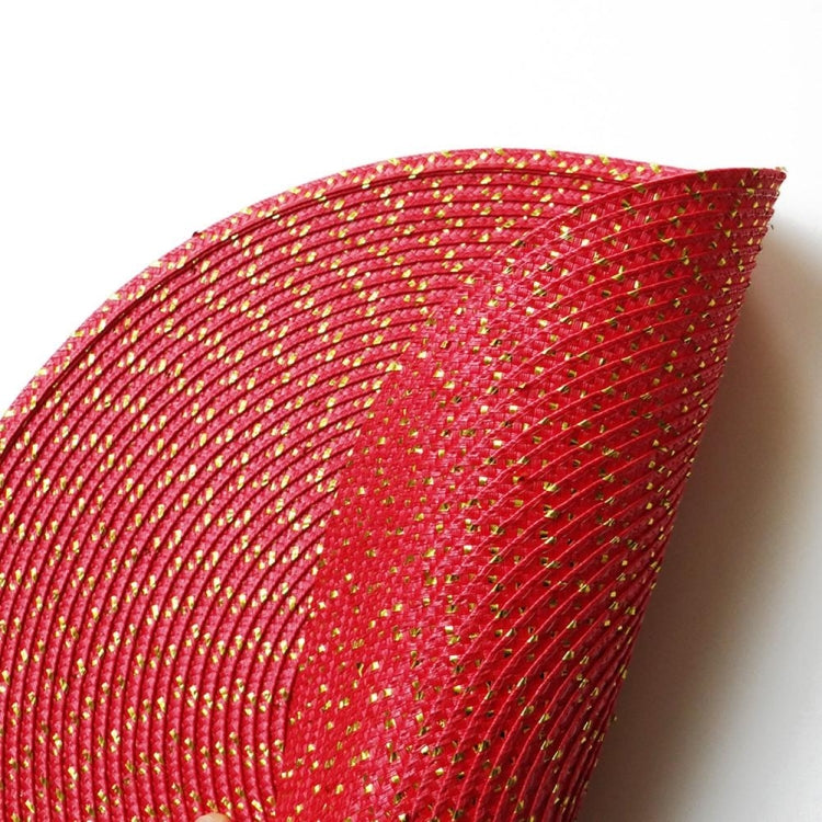 Close-up of red woven placemat with gold-toned speckled strands