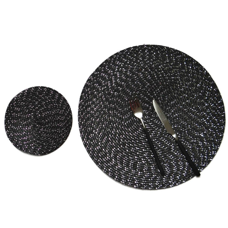 Two round woven placemats in dark gray speckled pattern, different sizes
