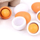 Toy egg set with orange and white plastic halves in shell cups