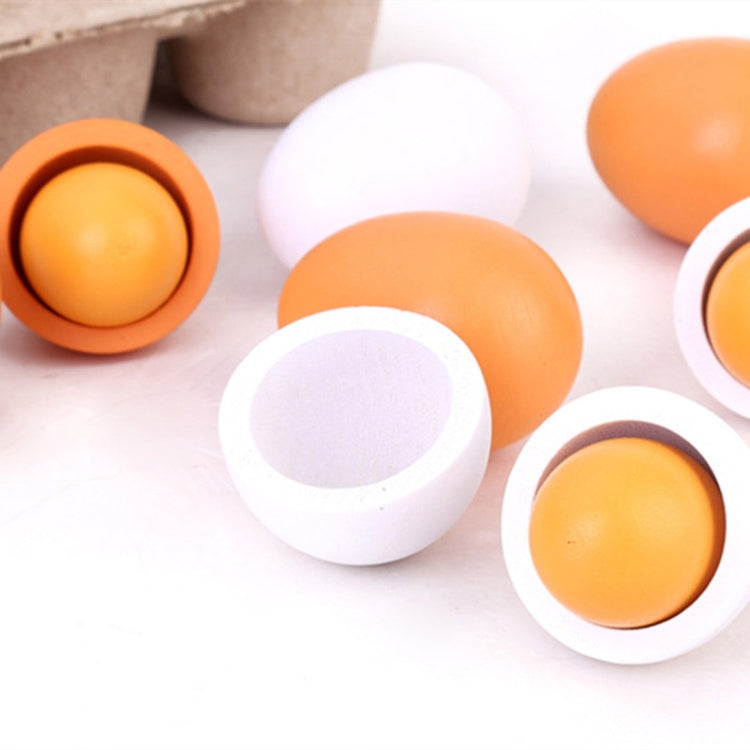 Toy egg set with orange and white plastic halves in shell cups