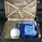Mini clothes dryer kit in open case with blue cover, white fan unit, and parts
