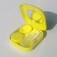 Yellow mini square contact lens case with mirror lid, two compartments, and tools