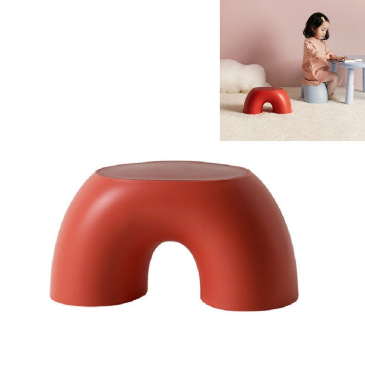 Red round kids stool with U-shaped cutout, wide stable seat.