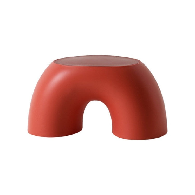 Red round children's stool with smooth curved sides and front cutout.