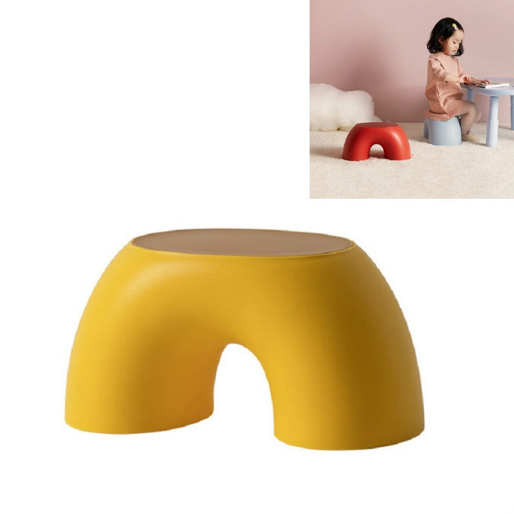Yellow round kids stool with smooth curved body, front cutout, and flat top.