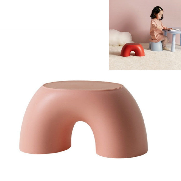 Pink round kids stool with front cutout and flat top.