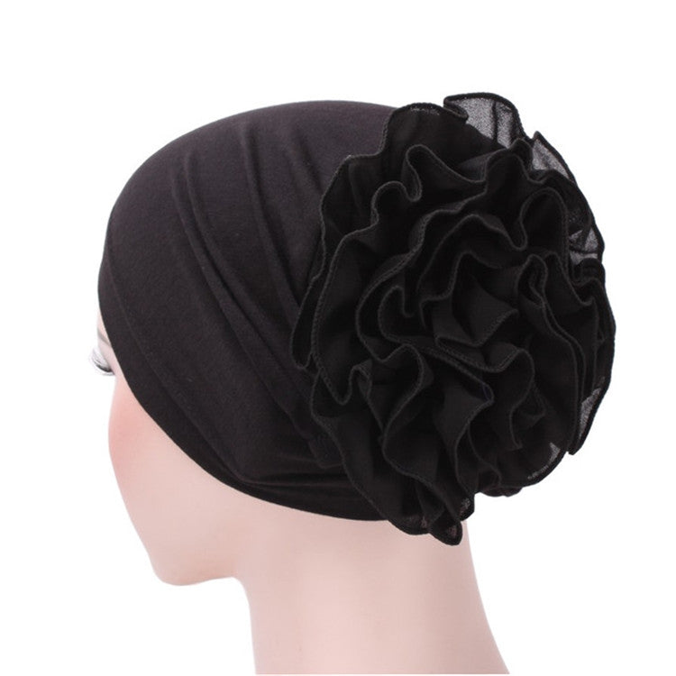 Black chiffon big-cap turban hat with side ruffle flower detail, one size