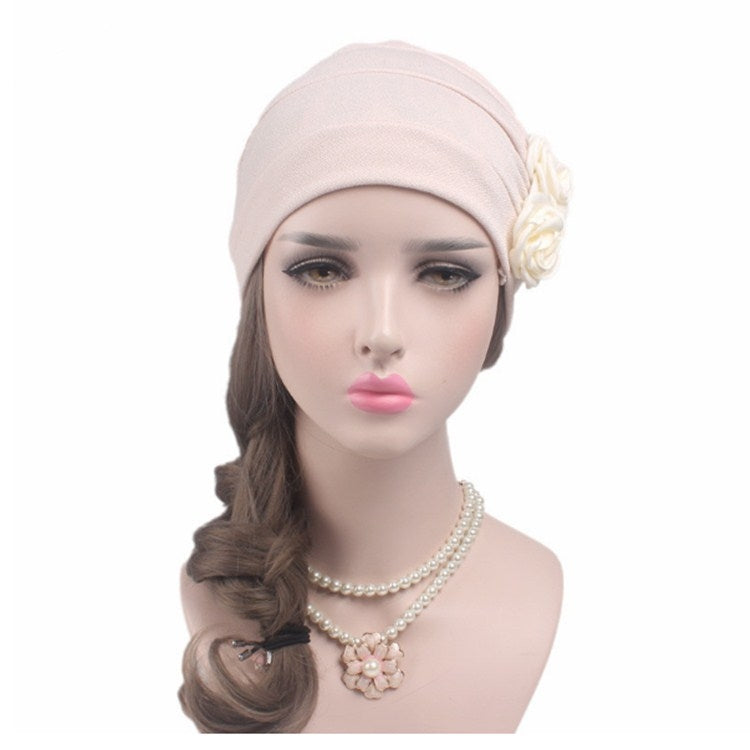 Light pink chemo cap with side fabric rose flower and pearl necklace accessory