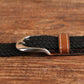 Narrow elastic canvas weave belt with black braided strap and brown leather keeper, silver buckle.