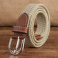 Narrow elastic canvas weave belt with light beige braid, brown leather keeper, silver double-prong buckle.