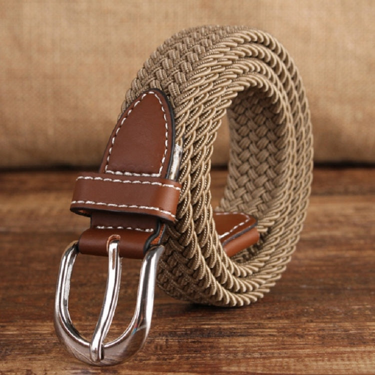 Narrow woven elastic belt with silver buckle, beige braided canvas, brown keeper.
