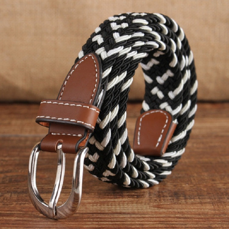 Narrow woven elastic belt with silver buckle, black-and-white braided canvas, brown keeper.