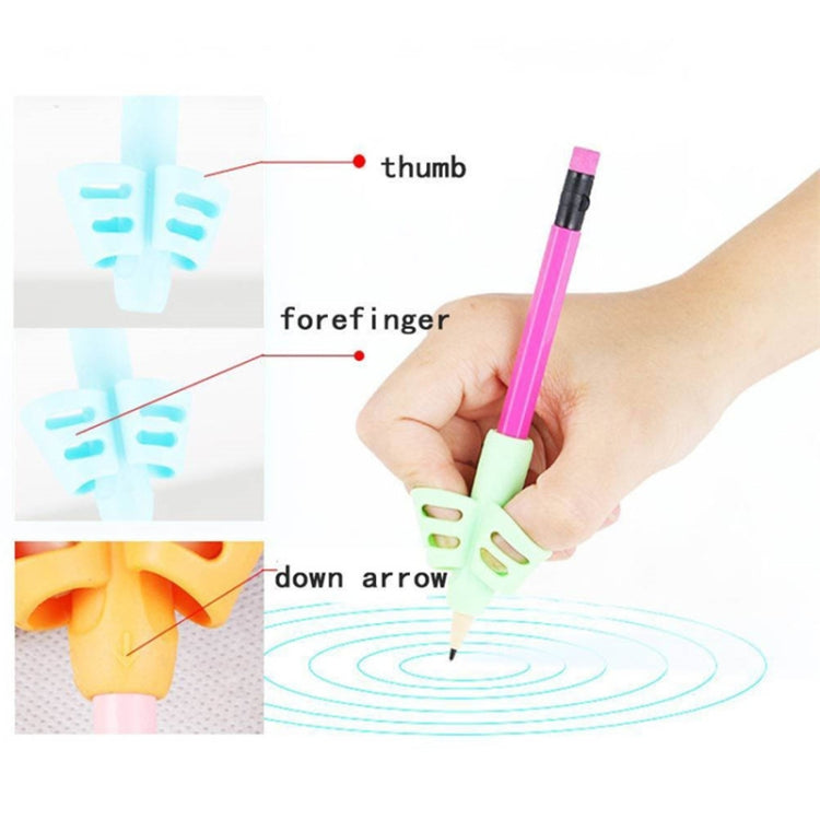 Children's pencil grip aid with green holder on pink pencil, finger guide