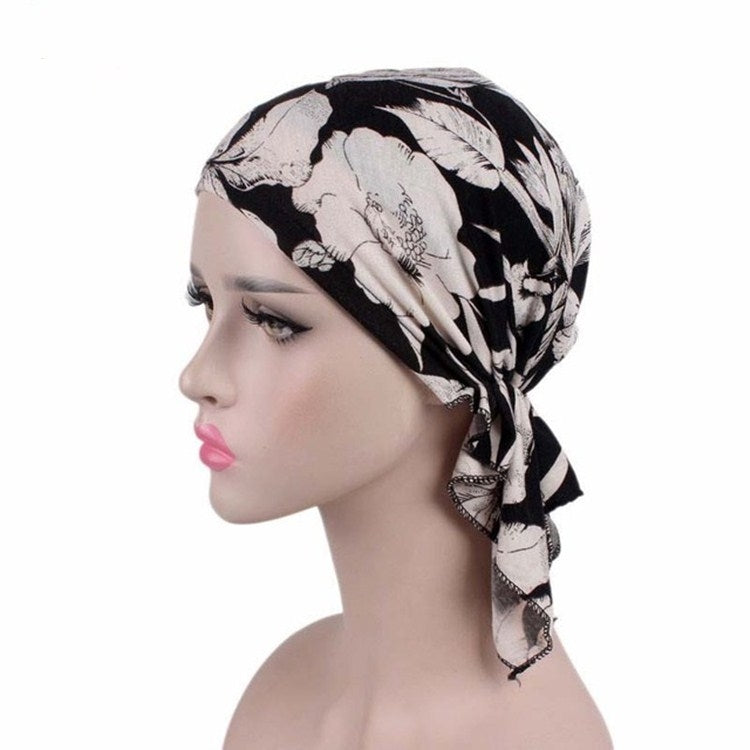 Black and white feather-print stretch turban cap with draped side knot