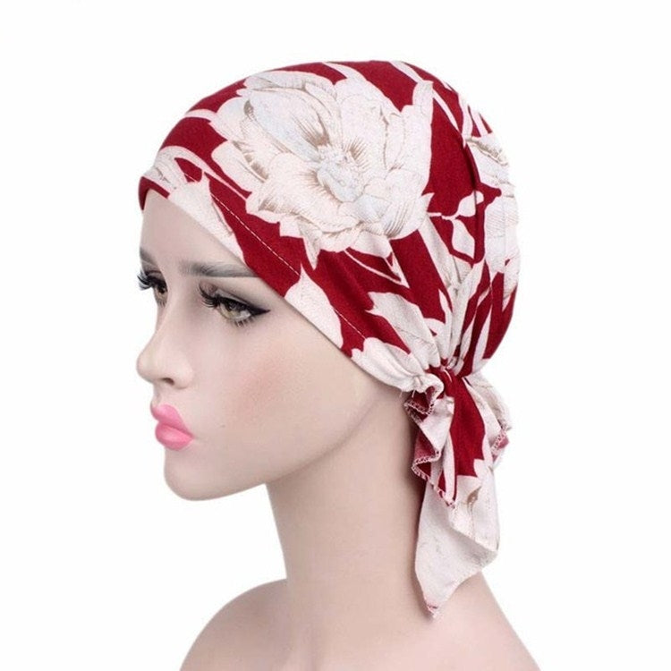 Red and white floral leaf-print stretch turban cap with side knotted tail