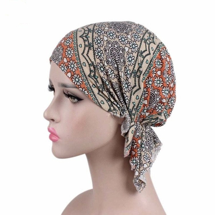 Beige orange floral paisley stretch turban cap with draped side knot