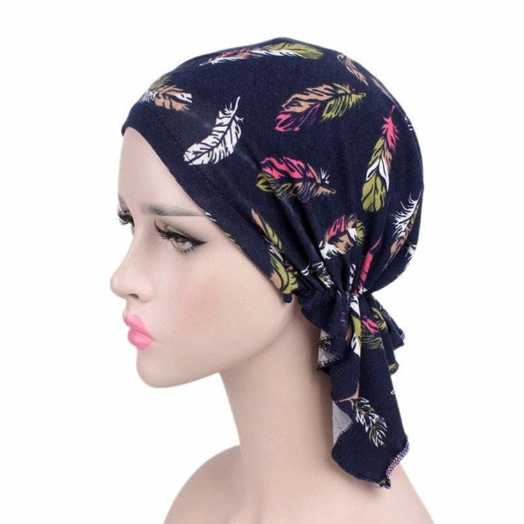 Navy blue leaf-print stretch turban cap with multicolor side drape and knot