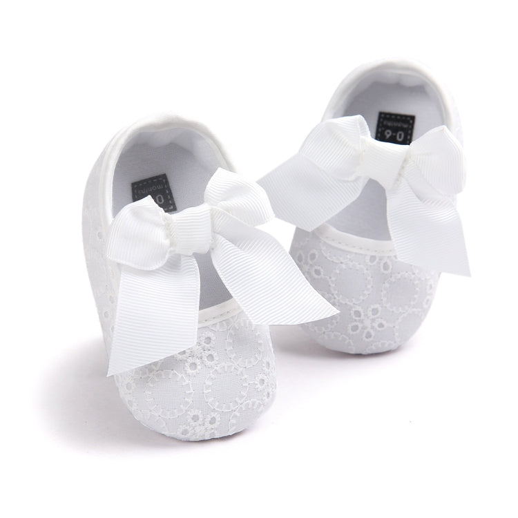 Toddler princess shoes in white with lace-style texture and large bow straps, soft sole