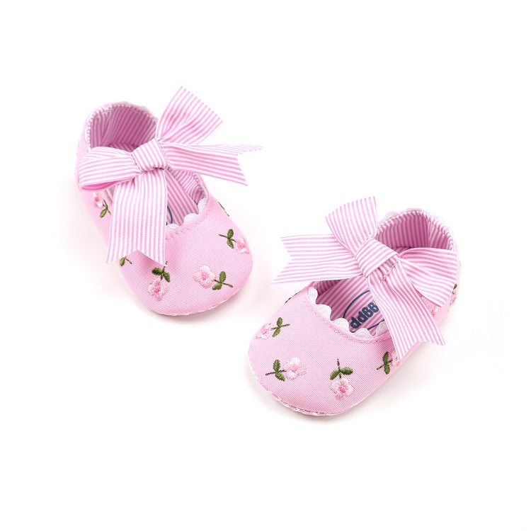 Pink toddler shoes with striped bows and tiny floral embroidery on the fabric, soft sole