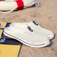 White breathable hollow slip-on sandals with perforated upper and dark trim
