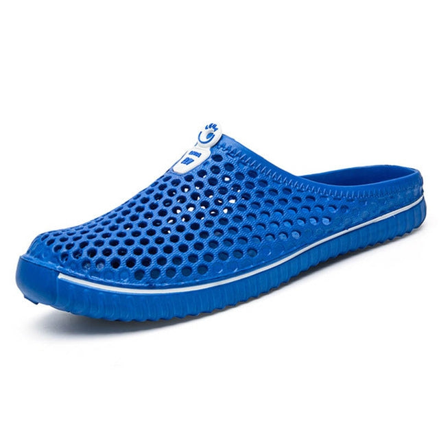 Breathable hollow sandals, blue perforated slip-on mule with curved toe and cushioned base.