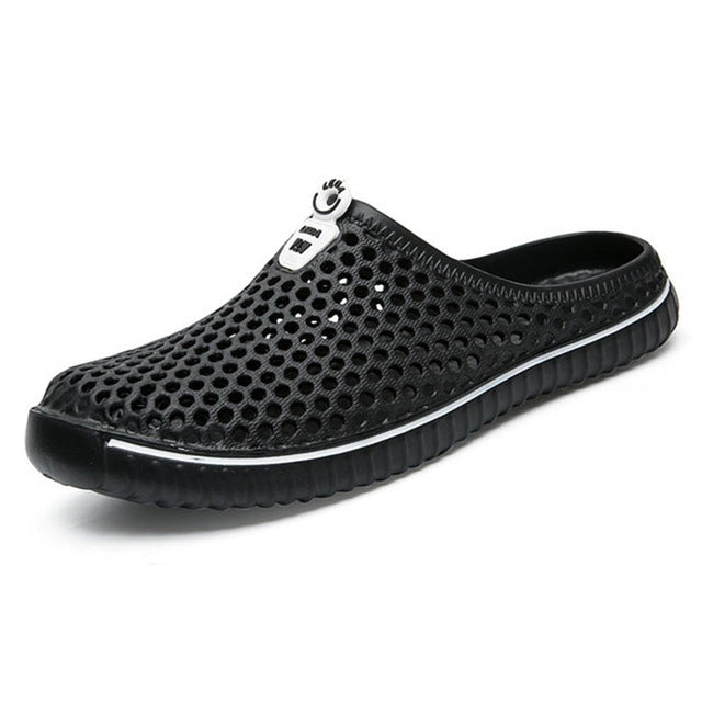 Black breathable perforated clog sandals, side view, with elastic slip-on design.