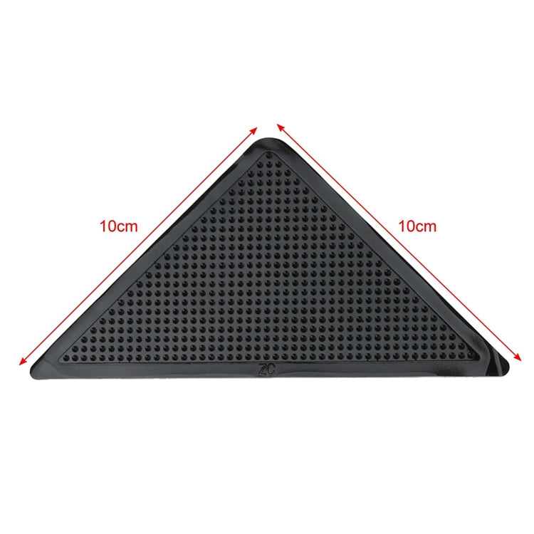 Triangular non-slip mat sticker, about 10 cm per side, black textured grip.