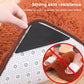 Triangular black non-slip sticker pressed onto carpet to help prevent sliding.