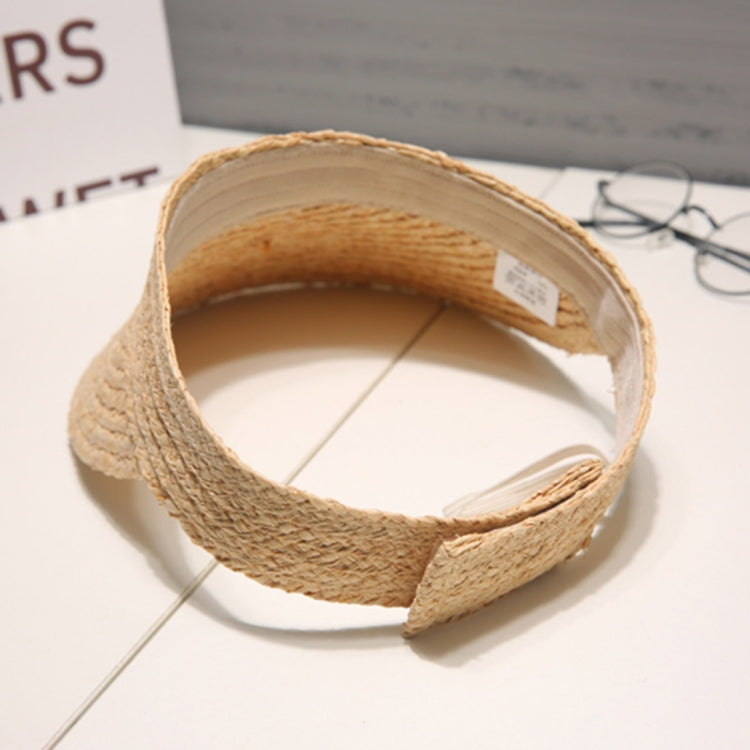 Woven straw visor hat interior view with wide brim edge and adjustable strap.