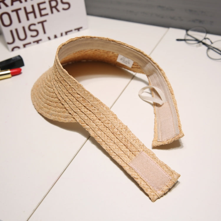 Woven straw visor hat underside view with adjustable chin strap and stitched rim.