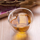 Heart-shaped double-wall glass mug with amber tea filling and transparent sides