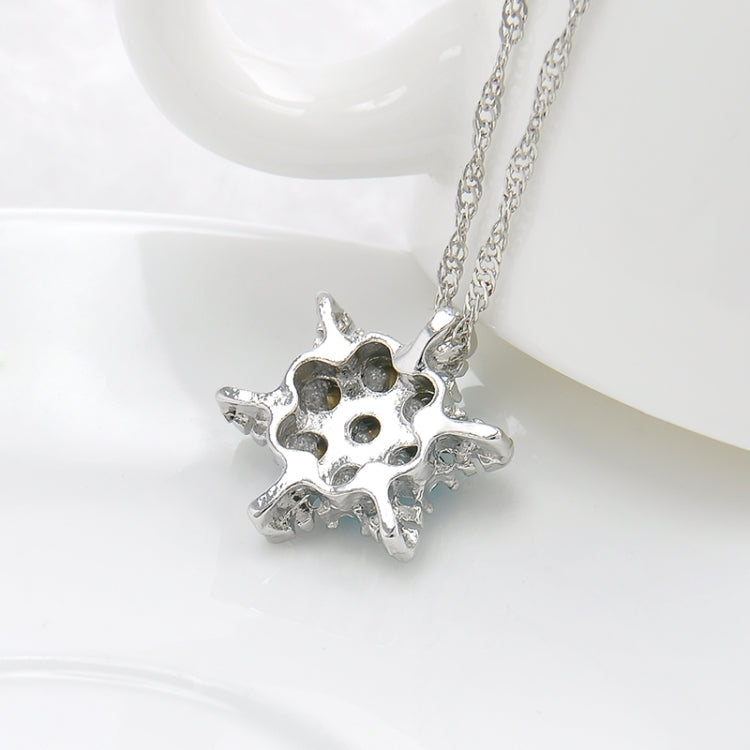 Silver-tone snowflake flower pendant with blue center stones on chain