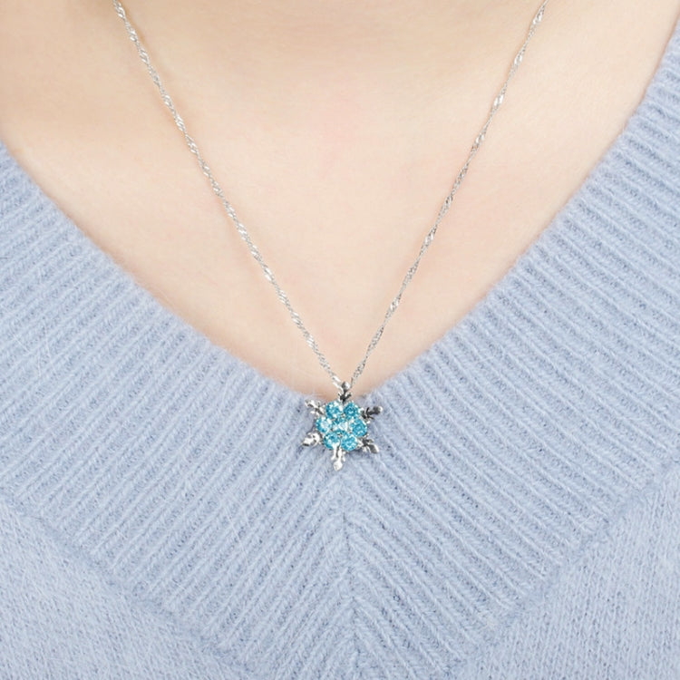 Silver-tone blue crystal snowflake flower pendant necklace worn on neck