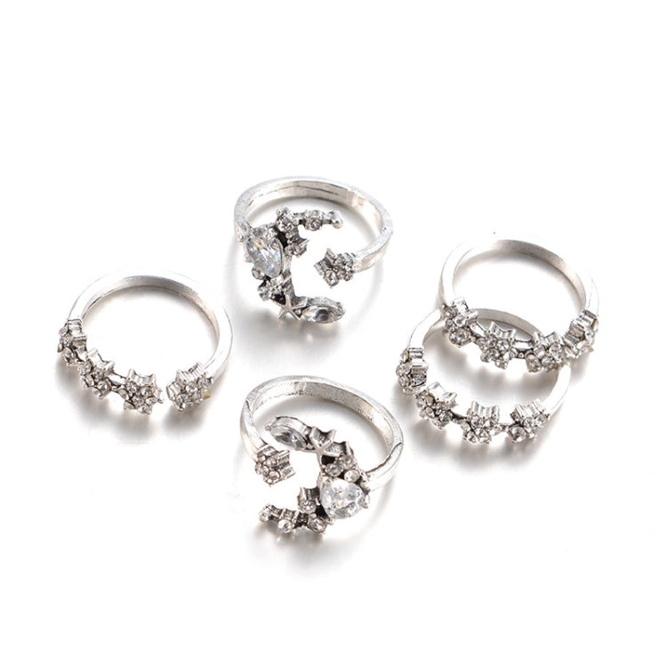 Set of five silver-tone adjustable rings with star and moon designs, front view